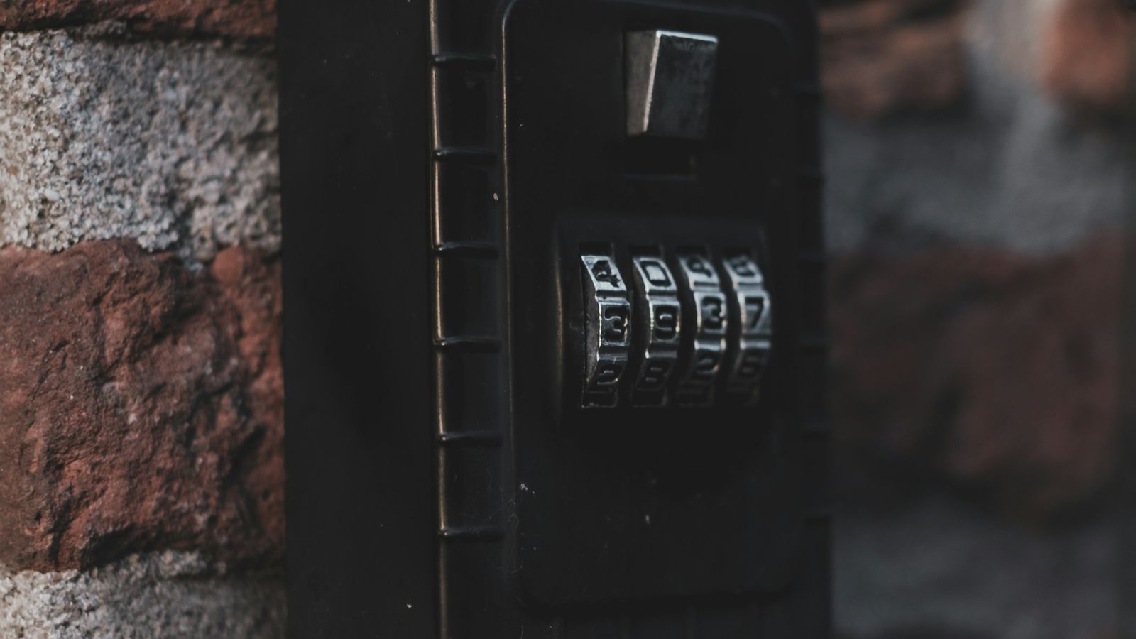 Combination key lock box on a brick wall